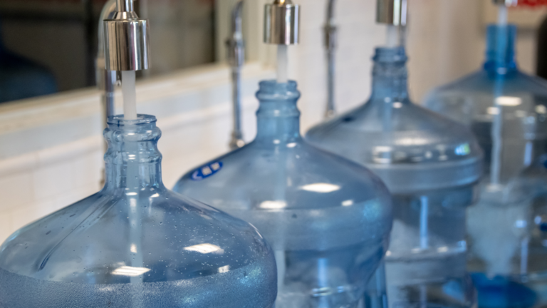 Filling round water gallons in a water refilling station business
